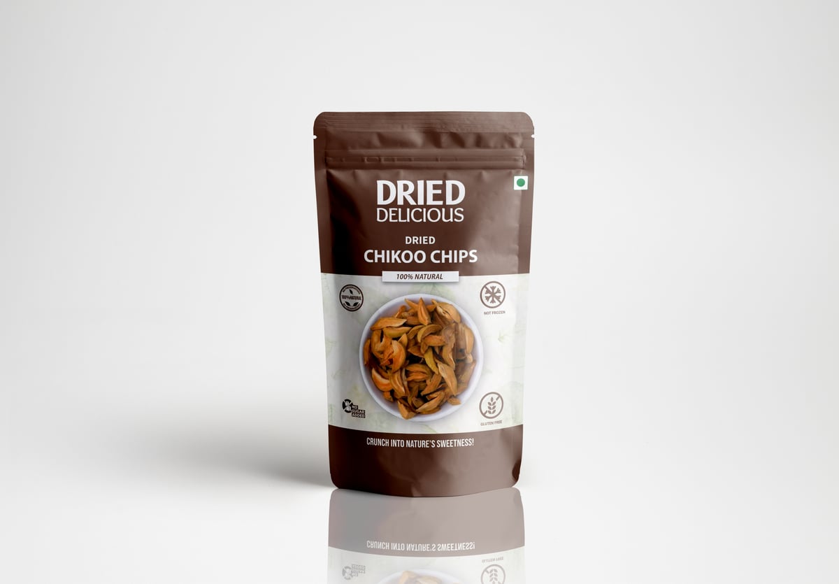 Stacks of sweet dried chikoo chips with rich caramel color on a light beige background with dramatic minimalist shadows - Image 1
