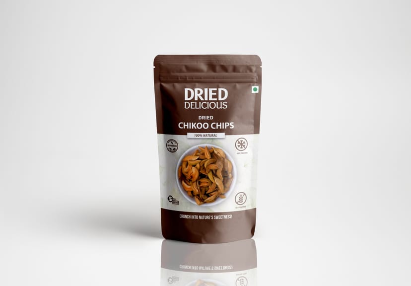 Stacks of sweet dried chikoo chips with rich caramel color on a light beige background with dramatic minimalist shadows