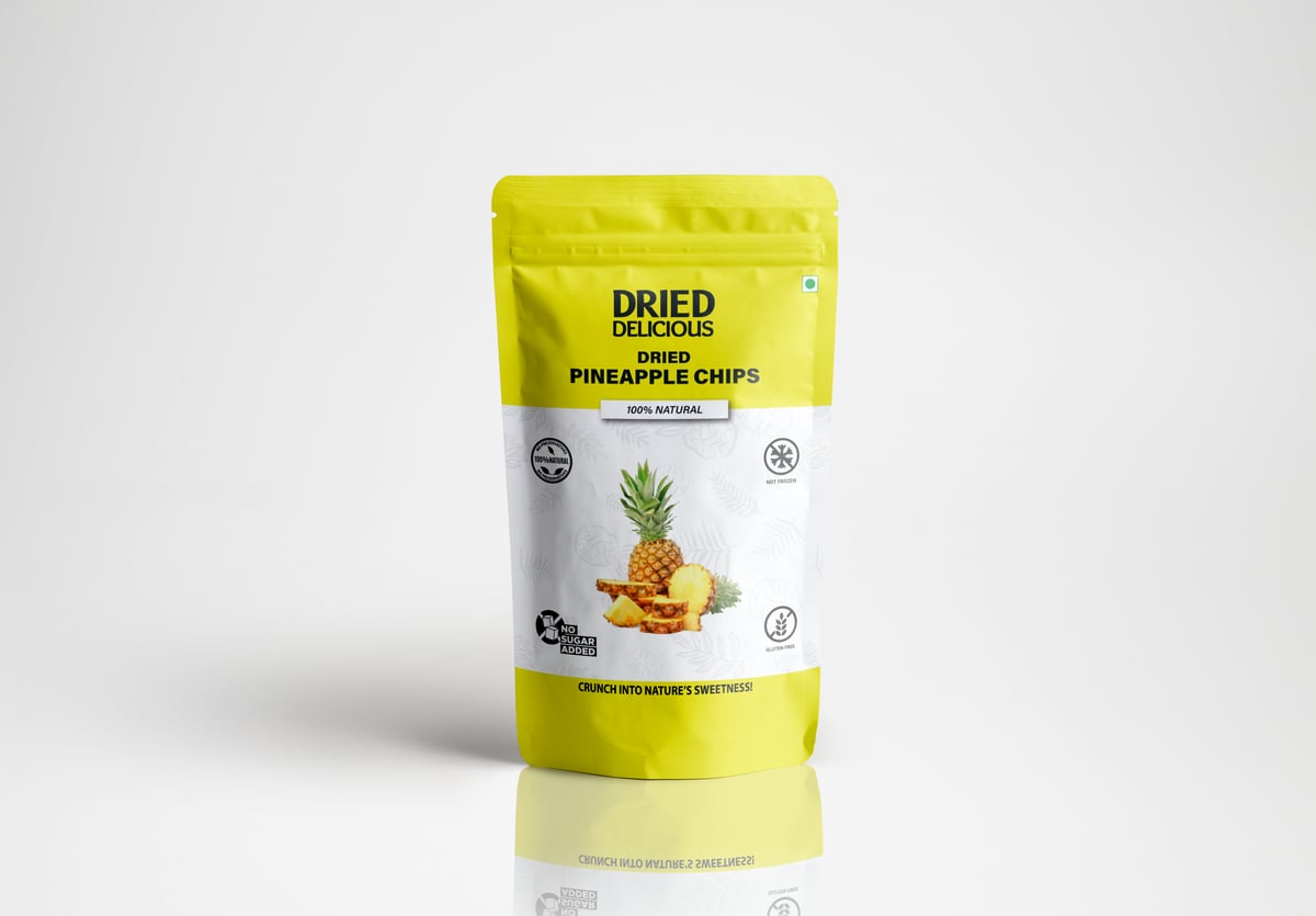 Stacks of bright orange dried mango slices on a light beige background with dramatic minimalist shadows - Image 1