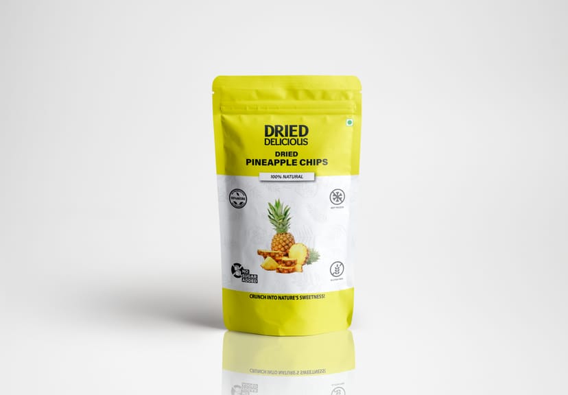 Stacks of bright orange dried mango slices on a light beige background with dramatic minimalist shadows