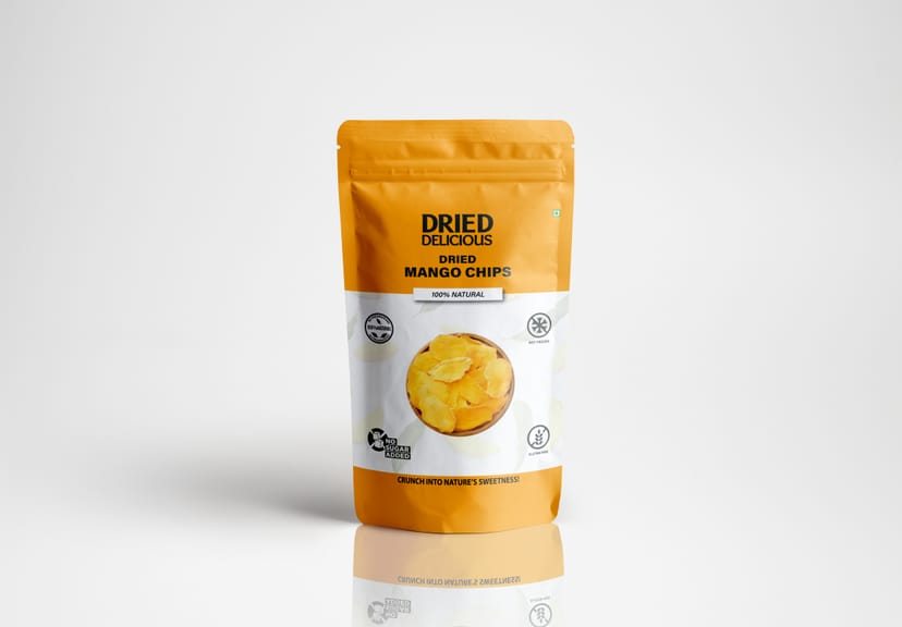 Stacks of bright orange dried mango slices on a light beige background with dramatic minimalist shadows